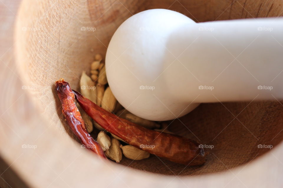 Pestle and mortar with spices. Pestle and mortar crushing up spices