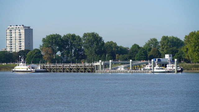 Landscape with river, ship and buildings at the riverside in Antwerp, Belgium.