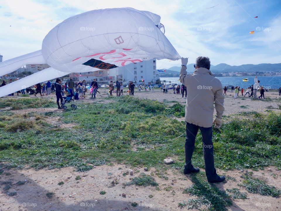 Elderly man playing with the kite