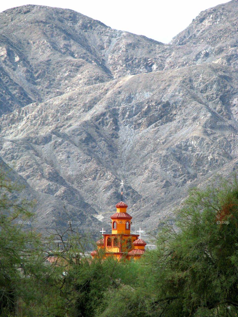 Orange church against mountains