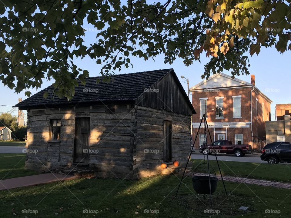 Town square of historic Knoxville, Illinois, with wooden house and masonic temple