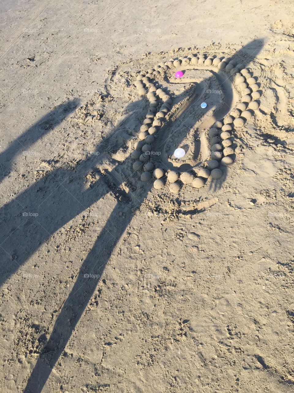 Shadow of child on sand