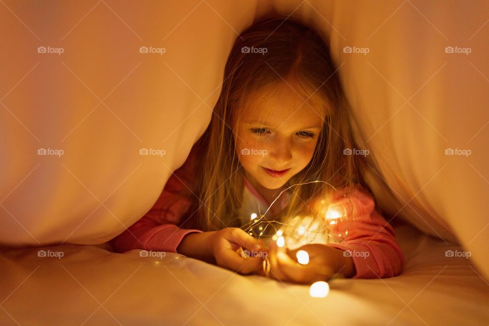 Girl playing in bed