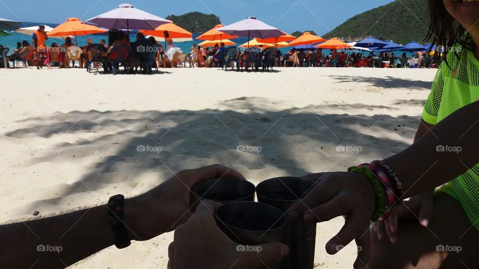 enjoying the view on the beach, colorful umbrellas that set the space and give a colorful rainbow