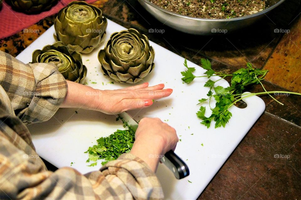 Chopping herbs for stuffed artichokes