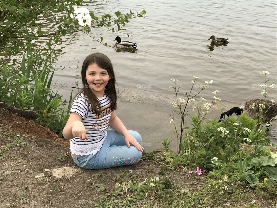 Girl by lake with ducks
