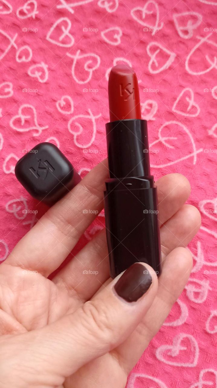 lipstick in the female hand beauty product love