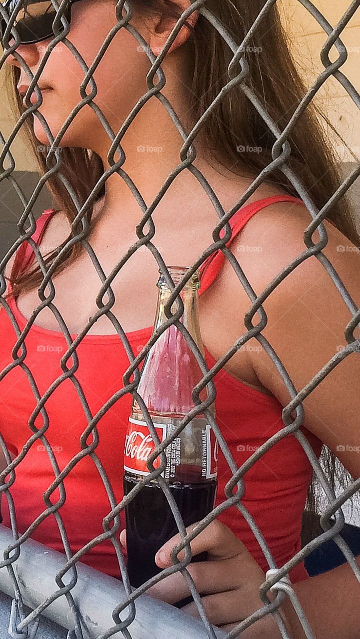 Close-up of a woman holding cold drink bottle