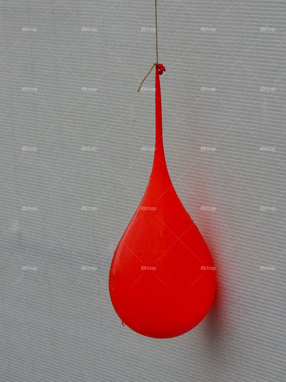 Red ballon on white wall