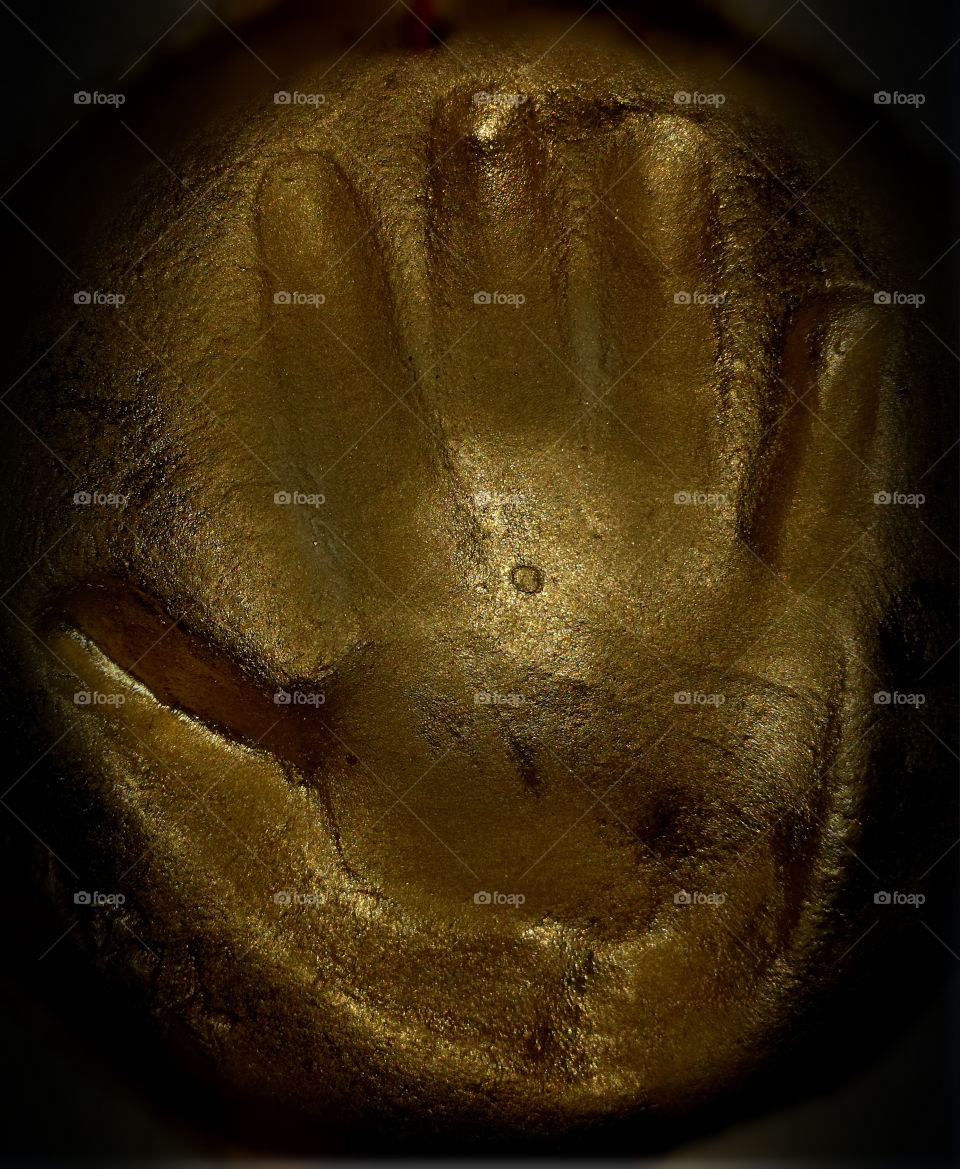 children's hand print in clay