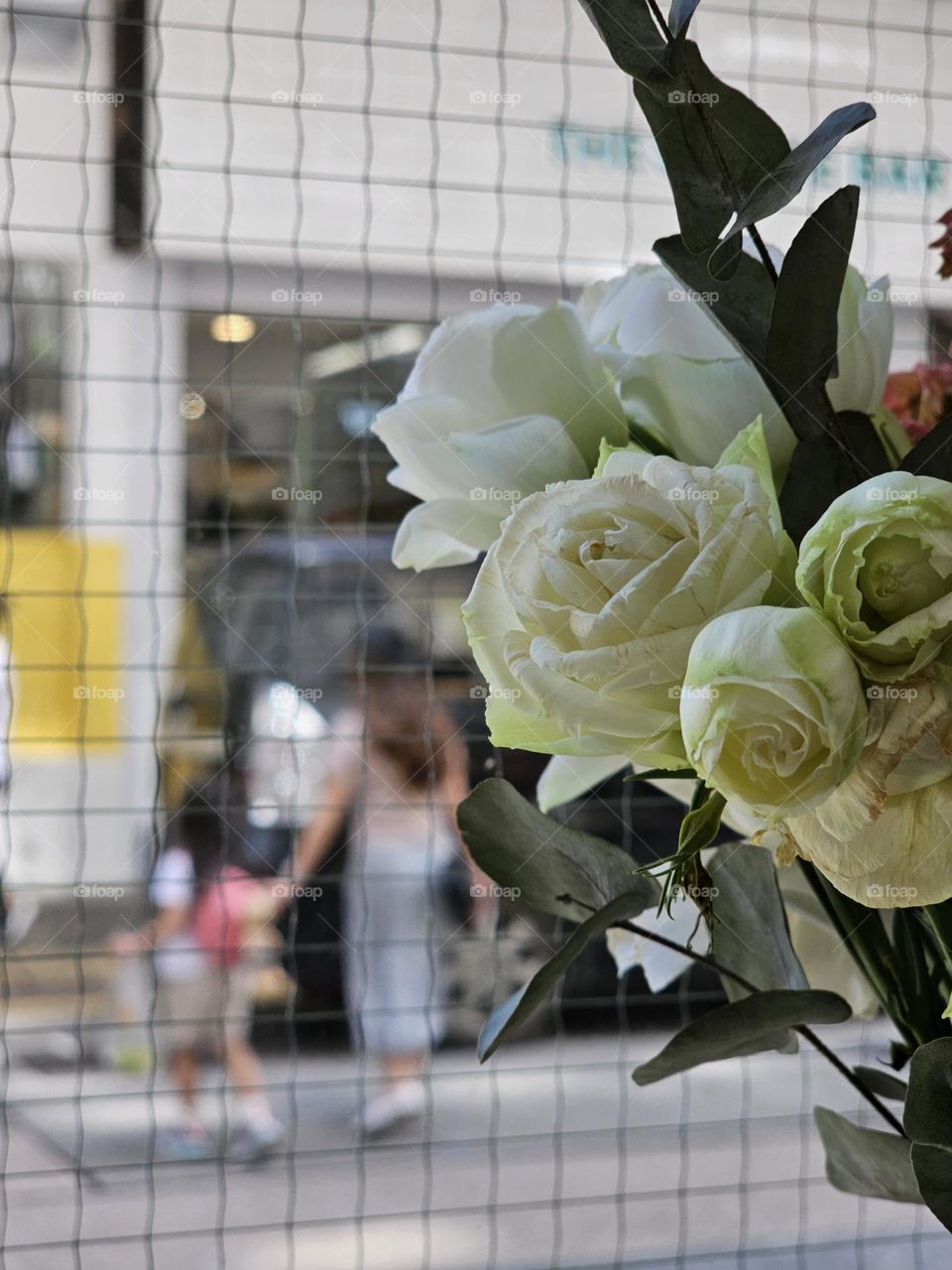 Summer in the city, looking out a cafe, watching the warm scene of mom going out with daughter on a weekday afternoon