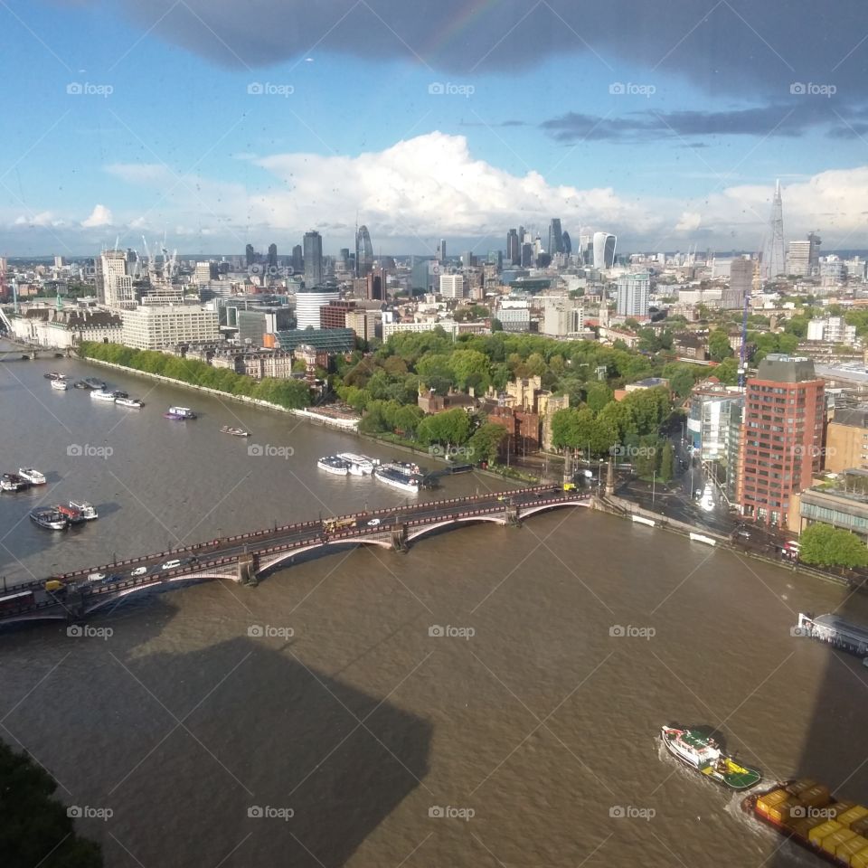 London city skyline over Pimlico featuring River Thames and boats bridge and clouds
