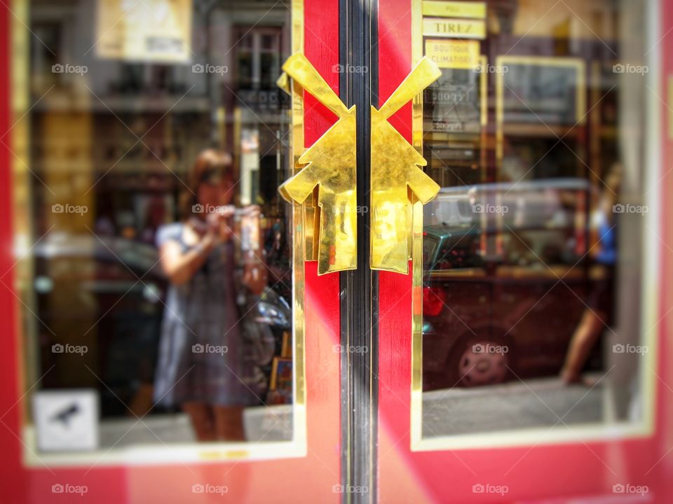handles on a red door in the form of a golden mill, Moulin Rouge, Paris