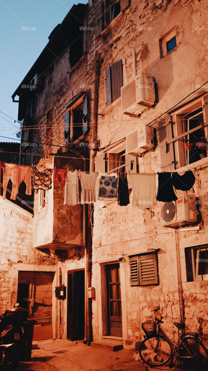 Washing hangs out in a backyard in Rovinj, Croatia, at dusk