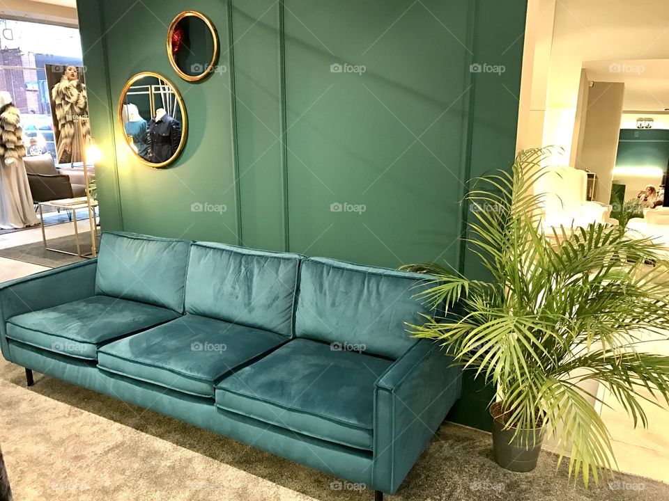 An interior with emerald sofa and walls