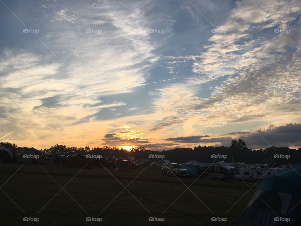 Sunset Over the field of tents, trailers, and trucks that is NASCAR Brooklyn Michigan. 