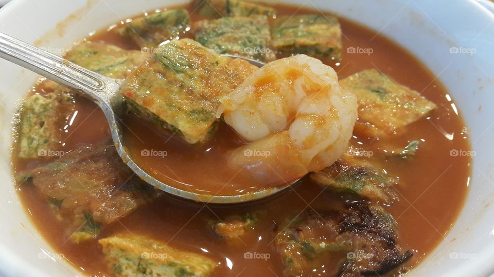 Kaeng Som Cha-om Kung (Thai sour curry with omelette and shrimps )