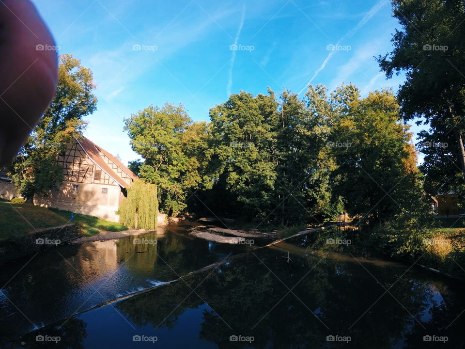 lovely river on a sunny summerday. the sky is blue, the leaves green.