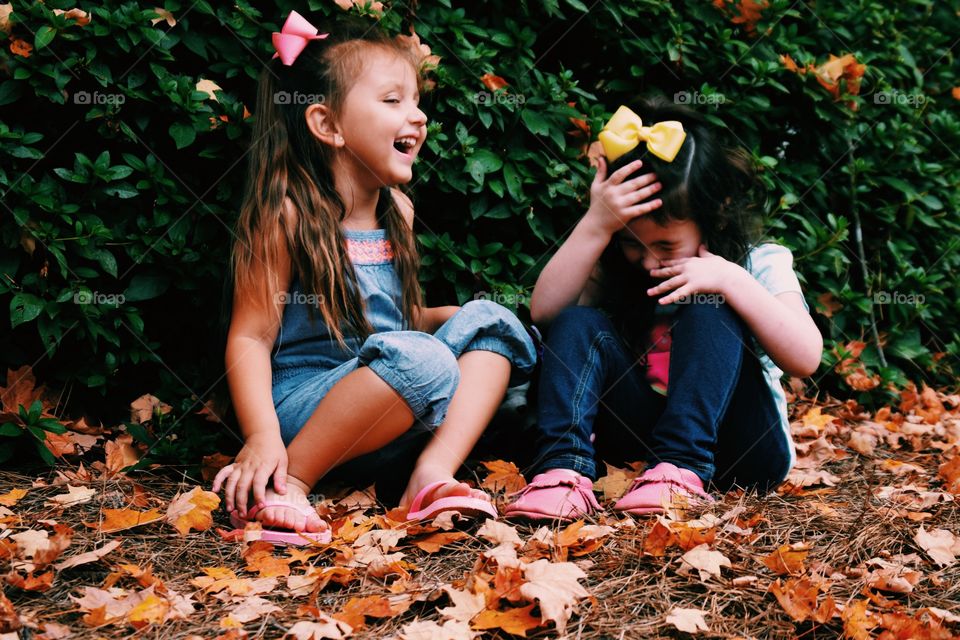 Two happy girls laughing outdoors