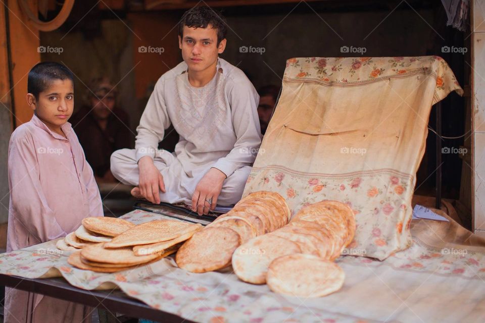 A naan stall in Pakistan managed by these 2 young boys.