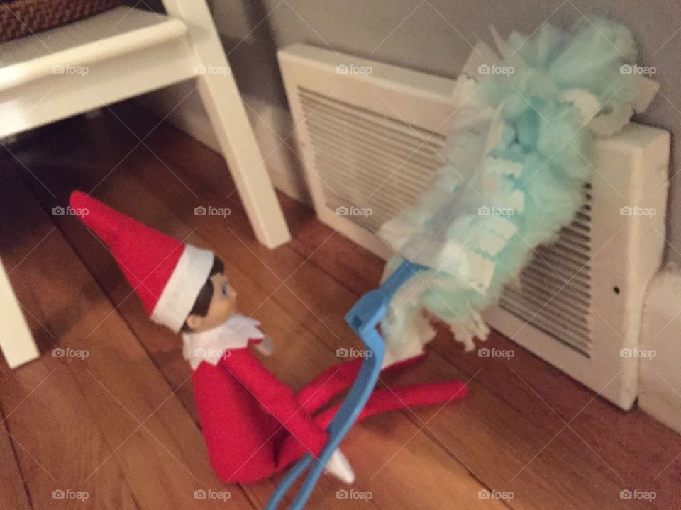 Elf on a shelf dusting doing chores
