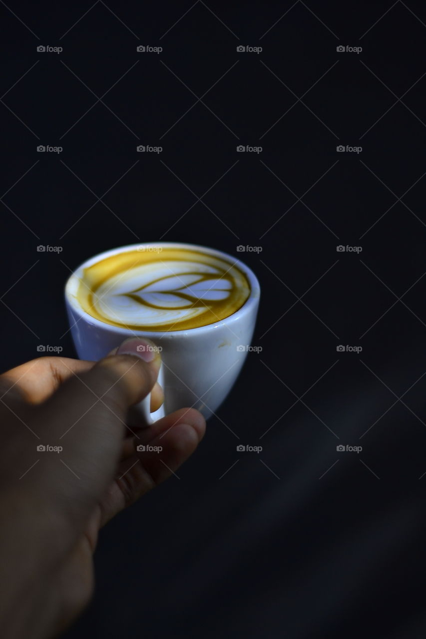 Person holding cup of coffee