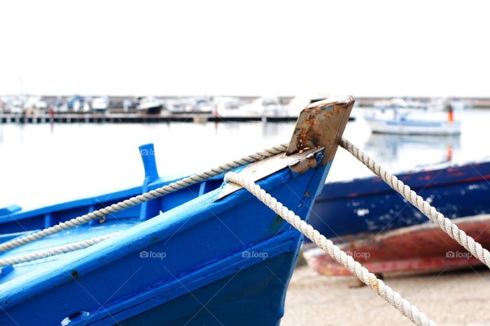 ancient boat moored to the shore