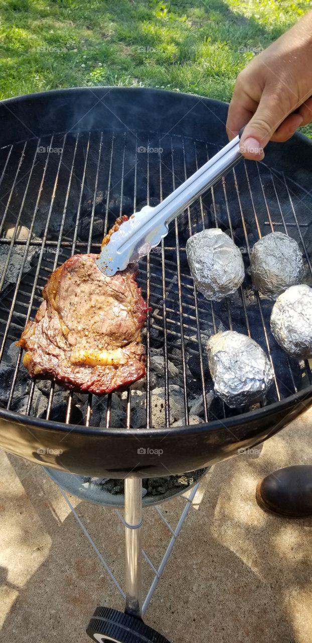 steak and potatoes on the grill