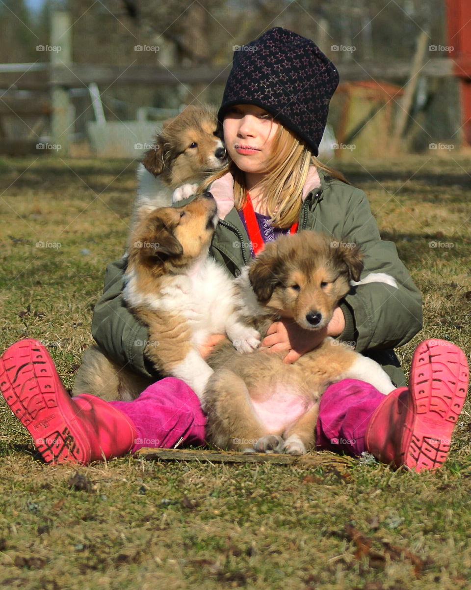 Small girl sitting with cute dog