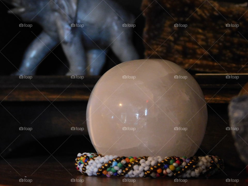 white crystal ball stone in hippie thrift shop