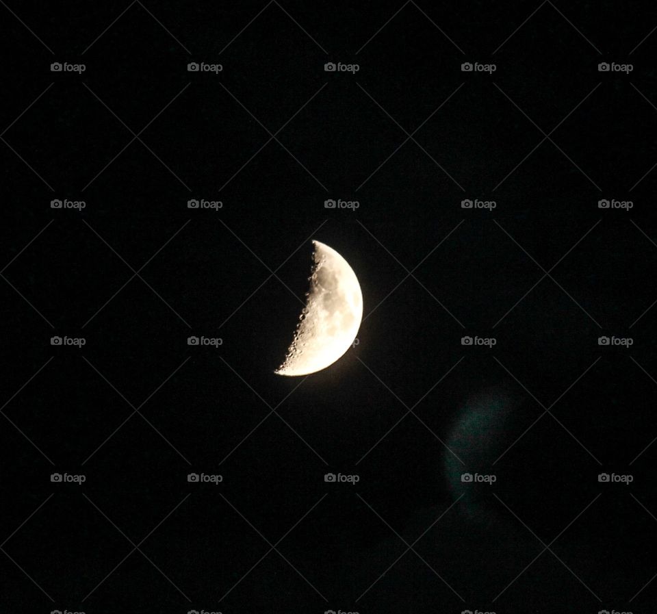 Crescent of half moon in sky at night