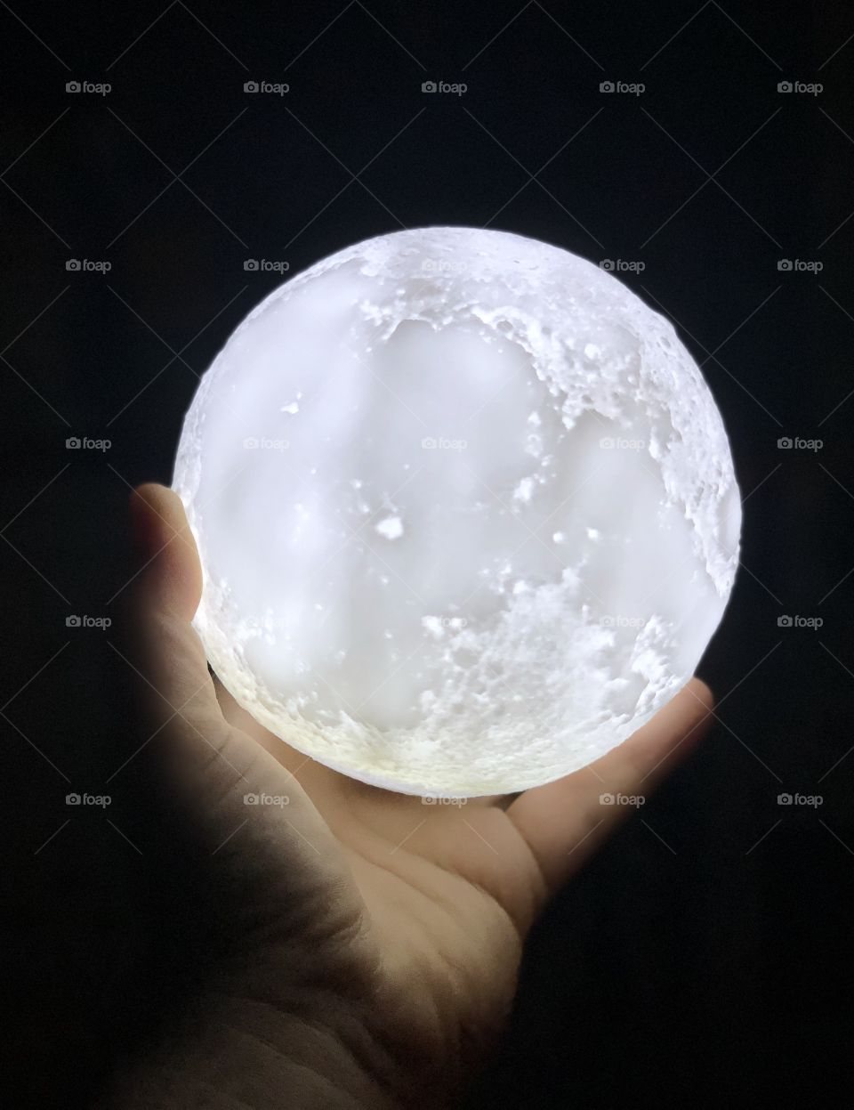 Hand holding the moon