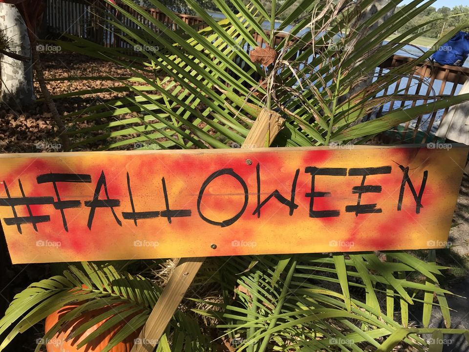 Falloween sign with green foliage 