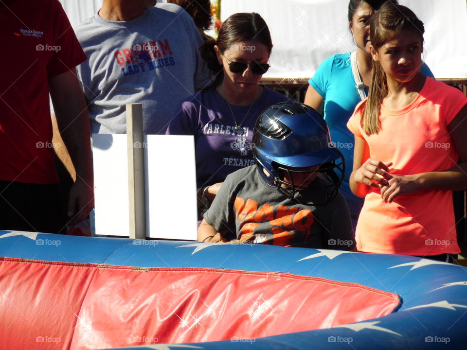 batter up. This is a picture of a young man about to ride a mechanical bull.