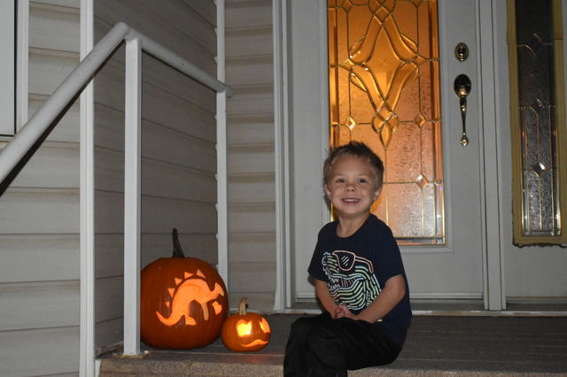 Sitting by jack-o-lanterns 