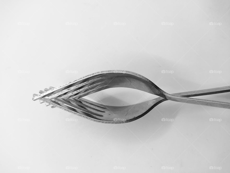 Two forks joined together, isolated on white background