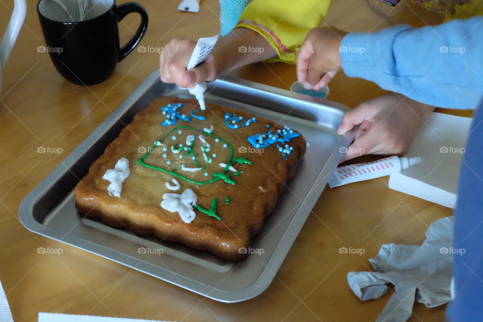 Kids decorating cake