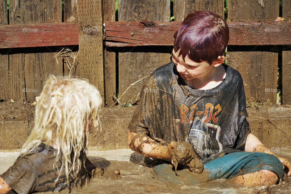 Kids Playing In Mud