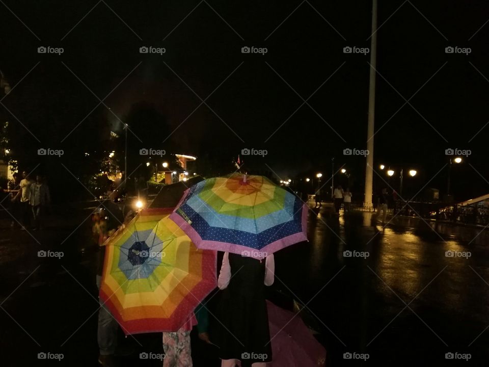 Beautiful colored umbrella in raniy season  at night.