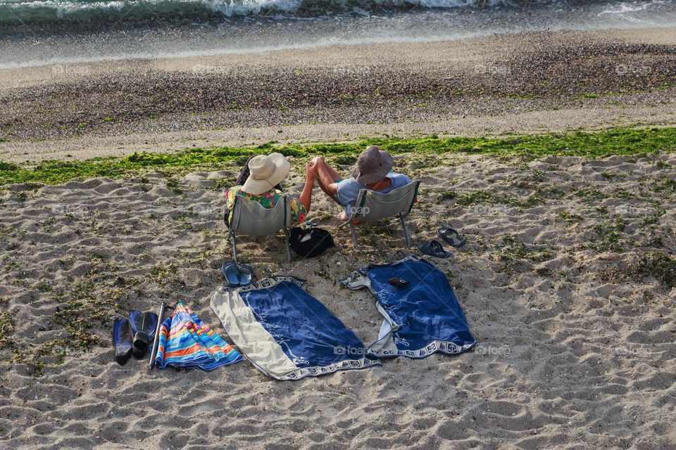 Back view of couple on the beach