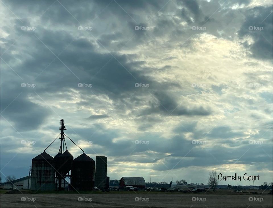 The storm rolling away over silos