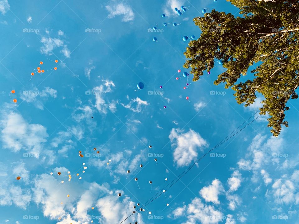 summer turquoise sky, white clouds and colorful balloons