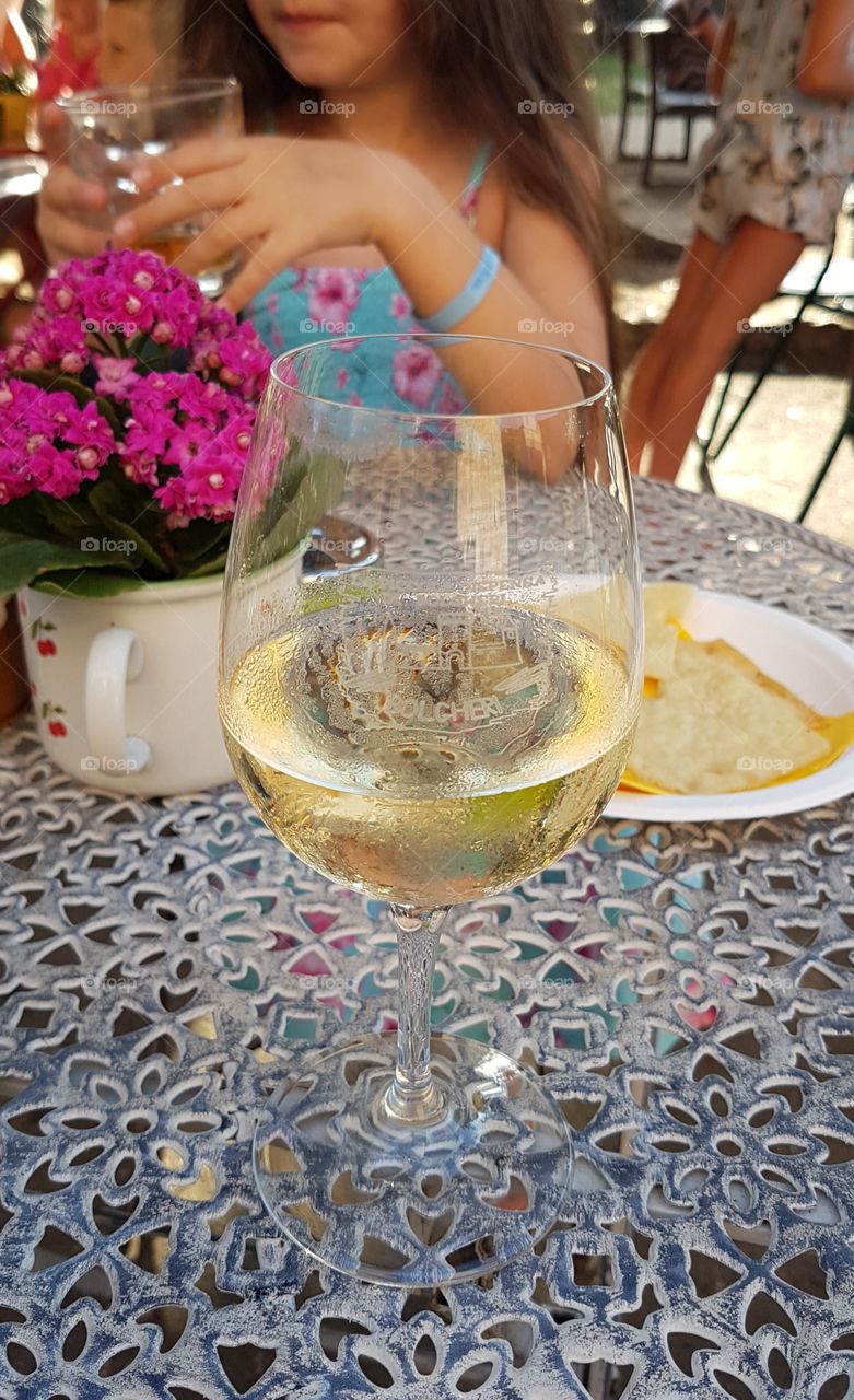 Glass of Tuscany white wine on a table outdoor