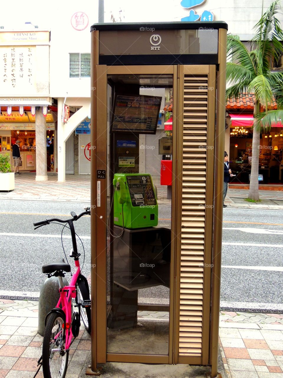 Bike & phone . Pink bike at a phone booth in Japan 