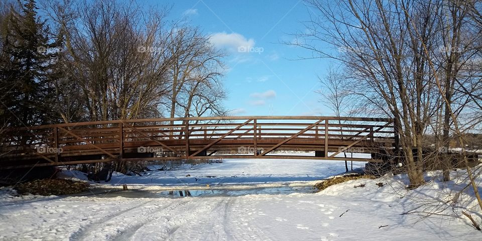 a bridge stretching out over a frozen river on Lake Johanna