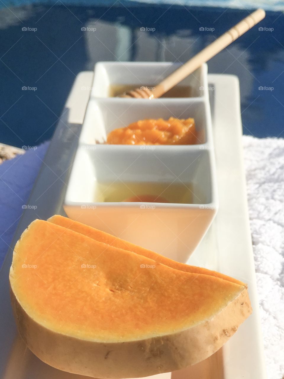 Cut orange squash slices foreground, recipe ingredients background 