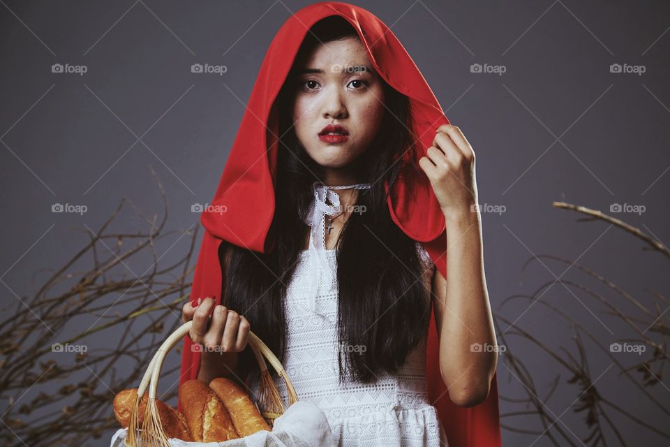 Asia girl holding basket of bread
