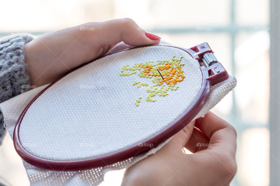 Woman embroider at cross