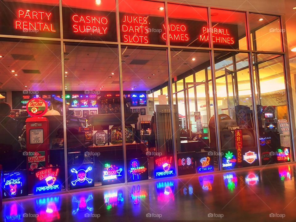 Festive storefront with vivid neon signs and fun decorations.