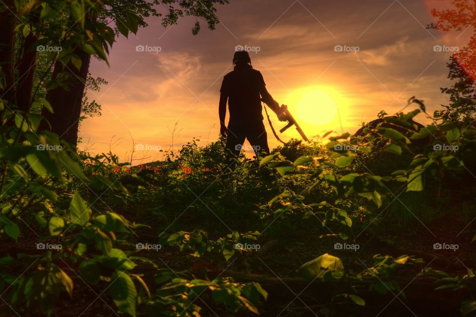 war is hell. friend and i playimg airsoft in my parents backyard. went to look at the sunset on an overlook. i wanted to try a few shots. this is what i got.